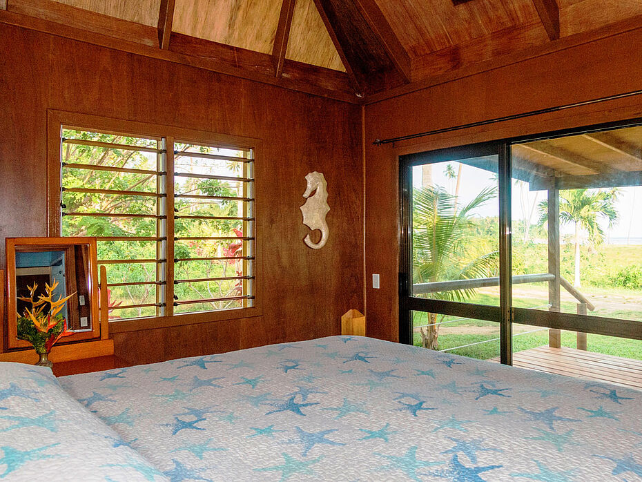 Bedroom no. 2 has ocean view with sliding glass door opening onto same large deck